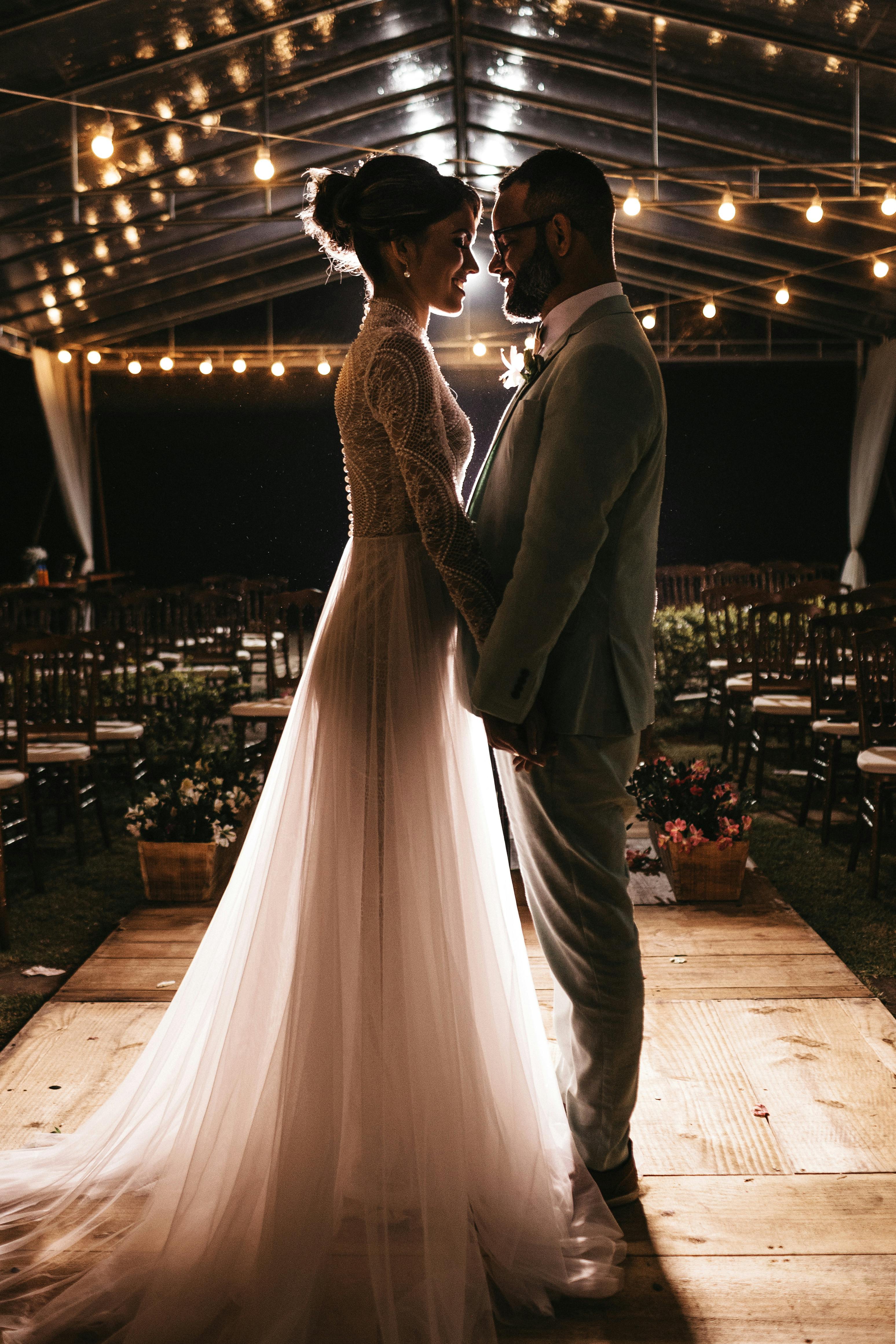 Bride and Groom standing in empty banquet hall 